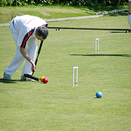 Photo of man playing croquet